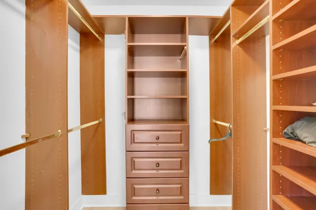 an aerial view of a house with a garden and lake view