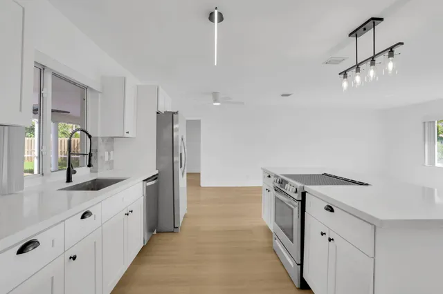 a kitchen with a sink and a refrigerator