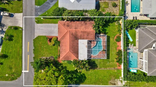 an aerial view of house with swimming pool outdoor seating and yard