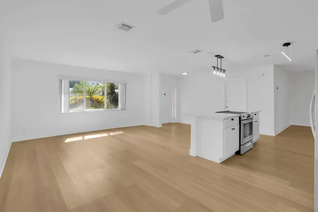 a large white kitchen with a sink and dish washer