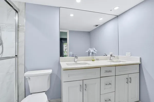 a bathroom with a toilet sink and mirror