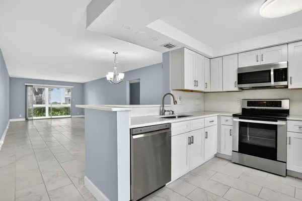 a kitchen with a sink stove and microwave