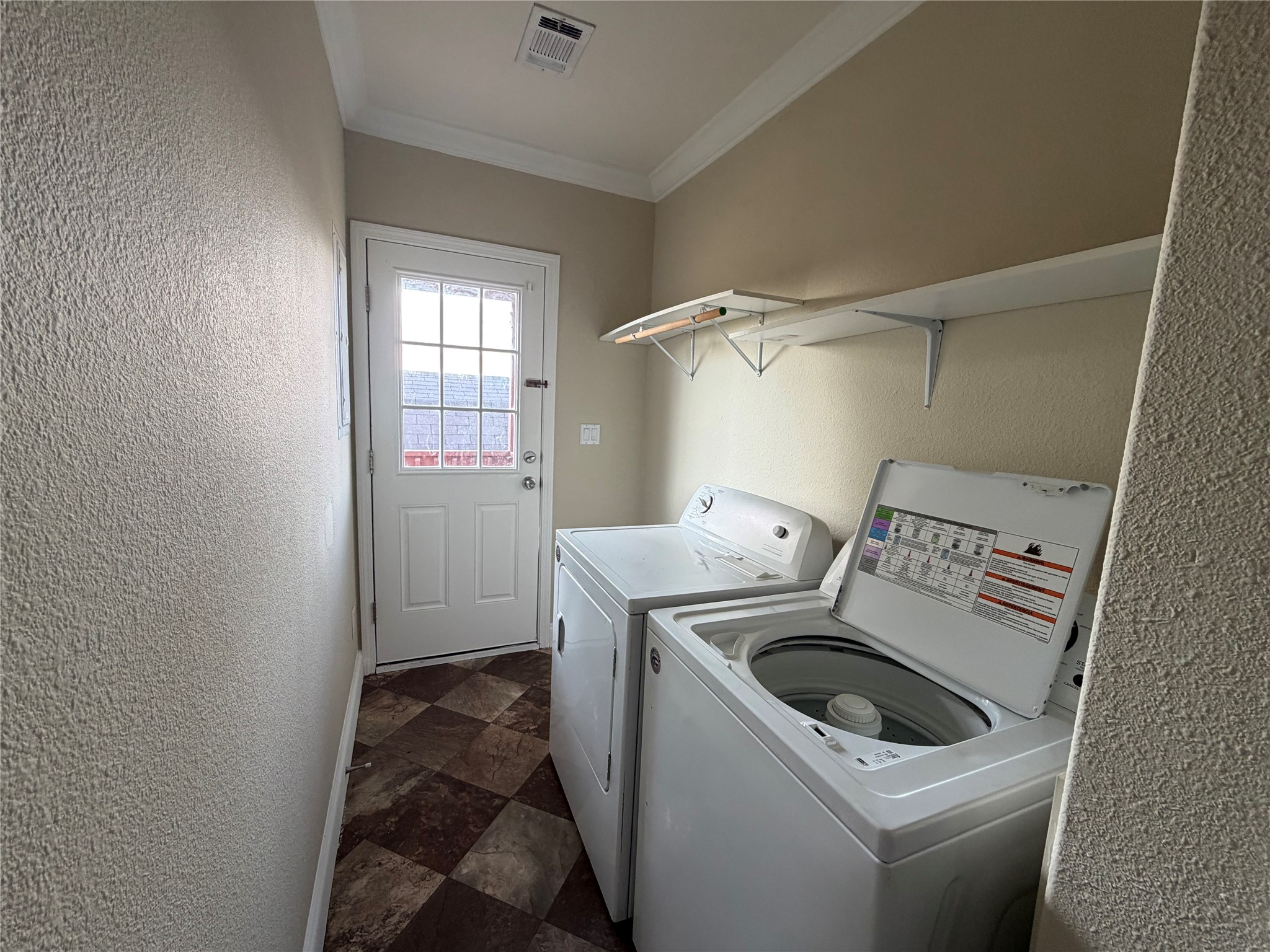 13021 Dessau Road, Unit 393 Austin, TX 78754 - Photo 10 of 10 Functional workspace features patterned flooring and convenient overhead shelving alongside access to the outdoors.
