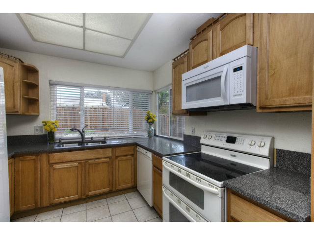 2801 Bridgeport Avenue San Ramon, CA 94583 - Photo 5 of 16 a kitchen with stainless steel appliances granite countertop a sink a stove a microwave cabinets and a counter top space