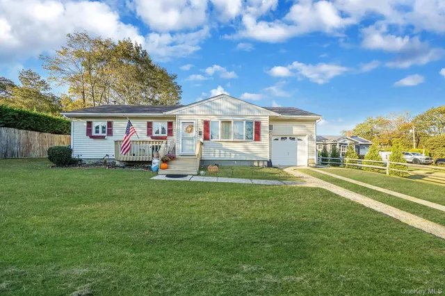 a front view of house with yard and outdoor seating