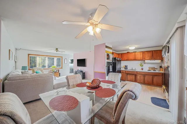 a living room with furniture a window and a flat screen tv