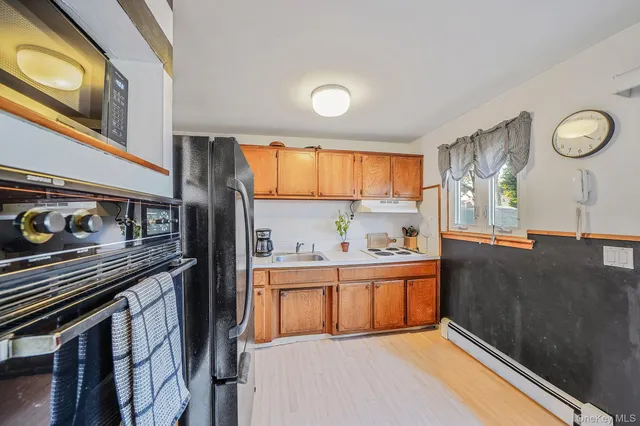 a kitchen with stainless steel appliances granite countertop a stove and cabinets