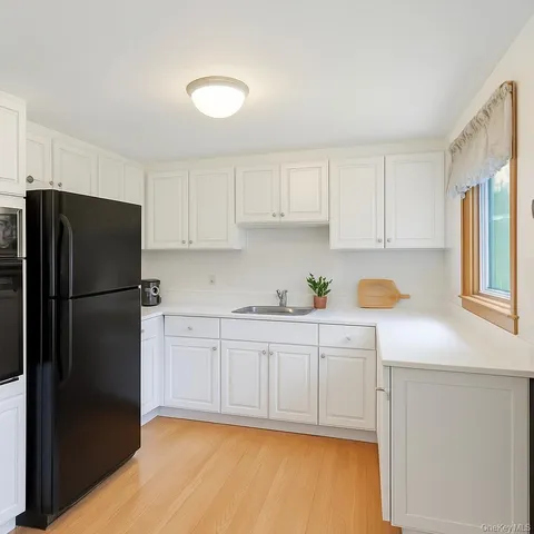 a kitchen with stainless steel appliances granite countertop a refrigerator sink and cabinets