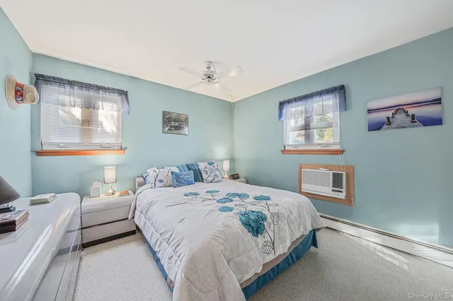 a bedroom with a bed couch and a window