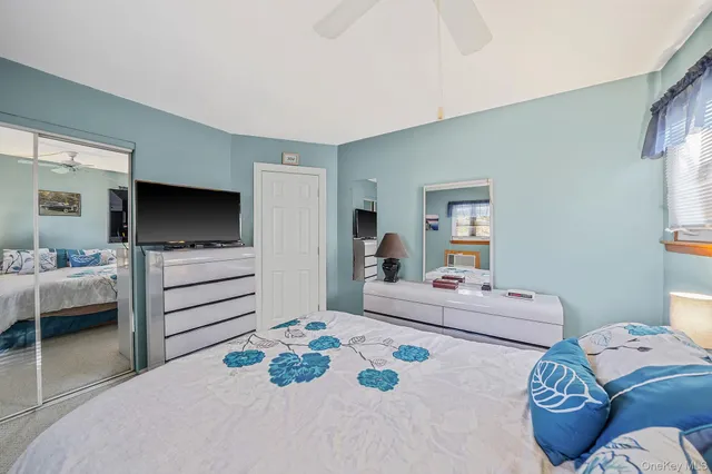 a bedroom with furniture and a flat screen tv