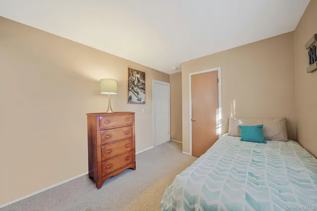 a bedroom with a bed and chair