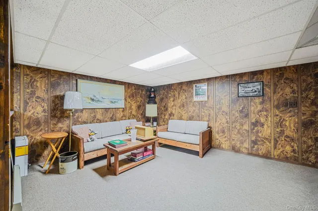 a living room with furniture and a wall painting