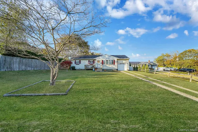 a view of house with outdoor space and garden