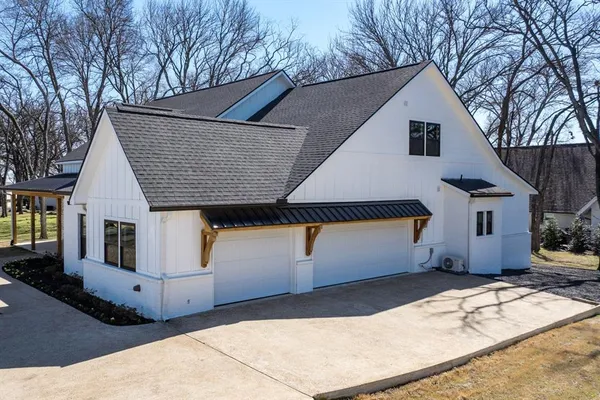 a view of a hallway with wooden floor fireplace and staircase