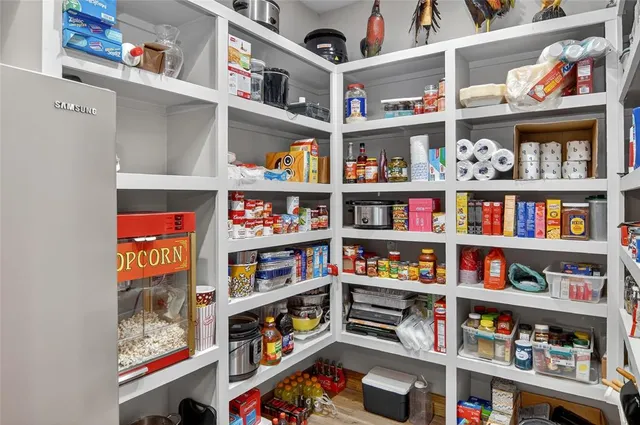 a dining room with furniture and a floor to ceiling window