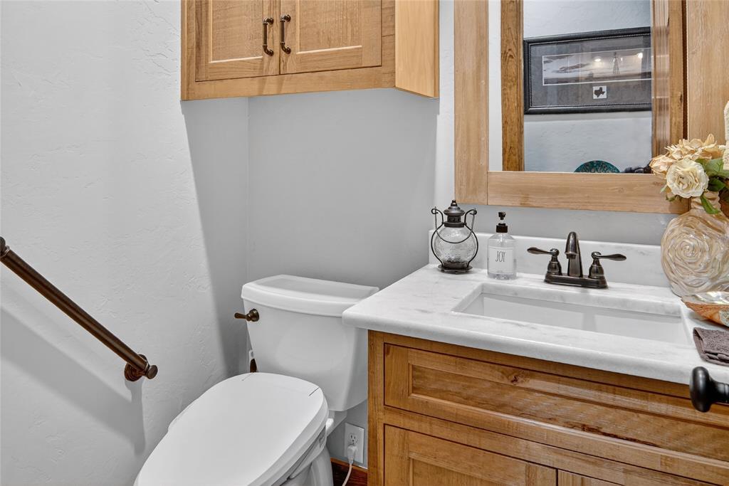 3016 W Highway Quitman, TX 75783 - Photo 17 of 40 a bathroom with a sink a toilet and a mirror