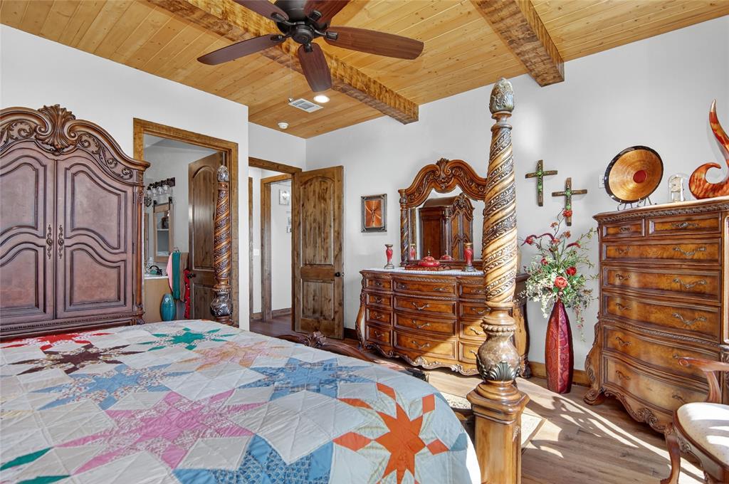 3016 W Highway Quitman, TX 75783 - Photo 19 of 40 a bedroom with a bed and a chandelier