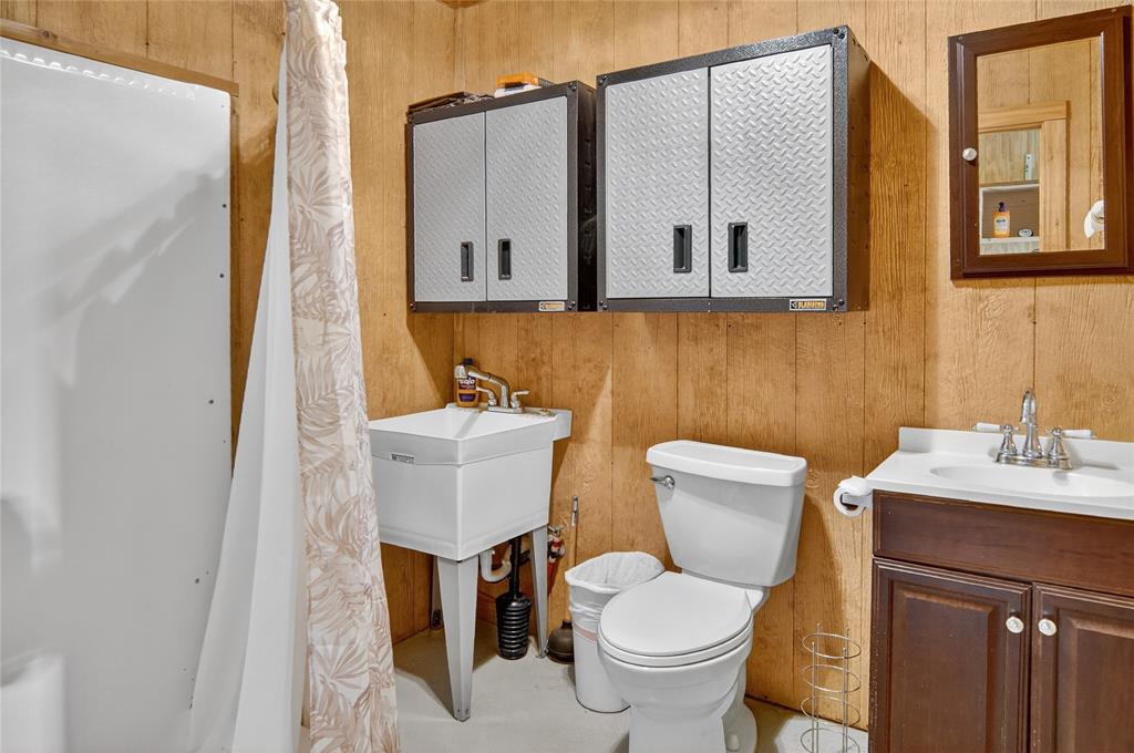 3016 W Highway Quitman, TX 75783 - Photo 30 of 40 a bathroom with a toilet sink and mirror