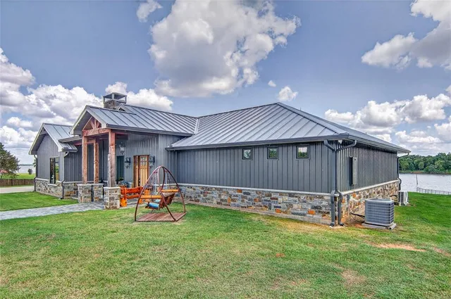 a backyard of a house with table and chairs
