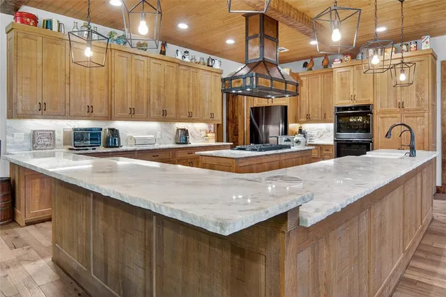 a kitchen with a stove and a white wooden cabinets