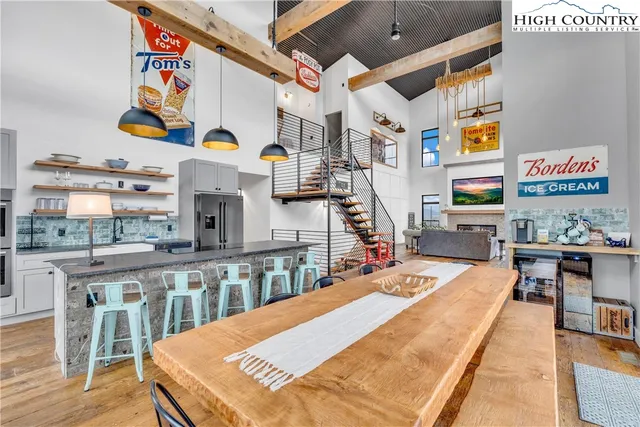 a view of a kitchen with kitchen island and stainless steel appliances