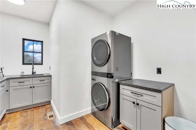 a utility room with sink dryer and washer