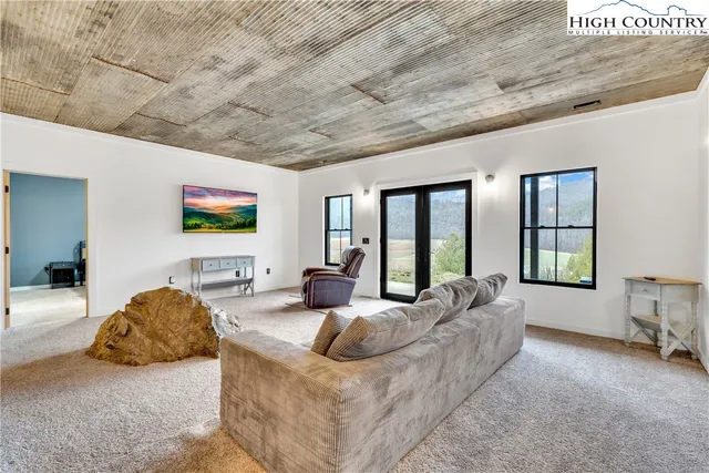 a bedroom with a bed and painting on the wall