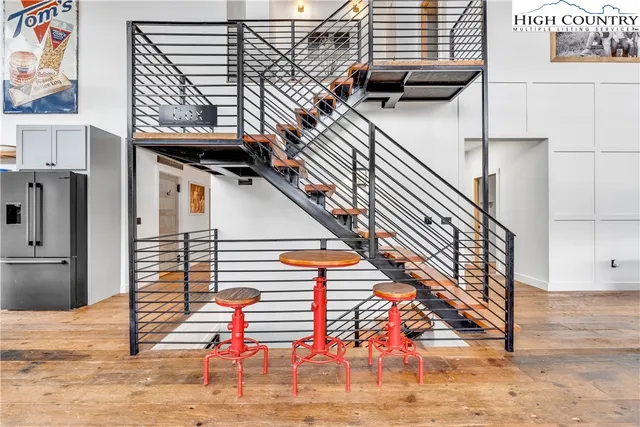 a view of a big room with windows and kitchen view