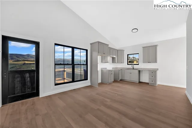 a view of an empty room with a window and washer