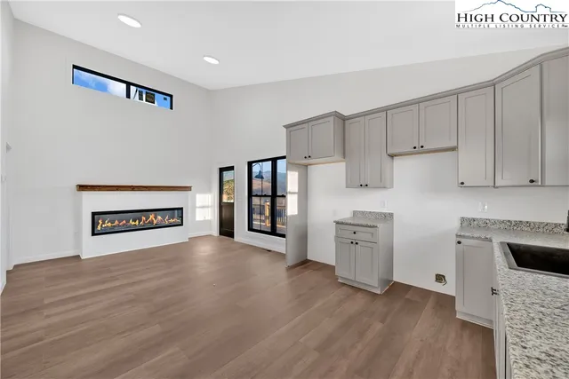 a view of a room with wooden floor and a window