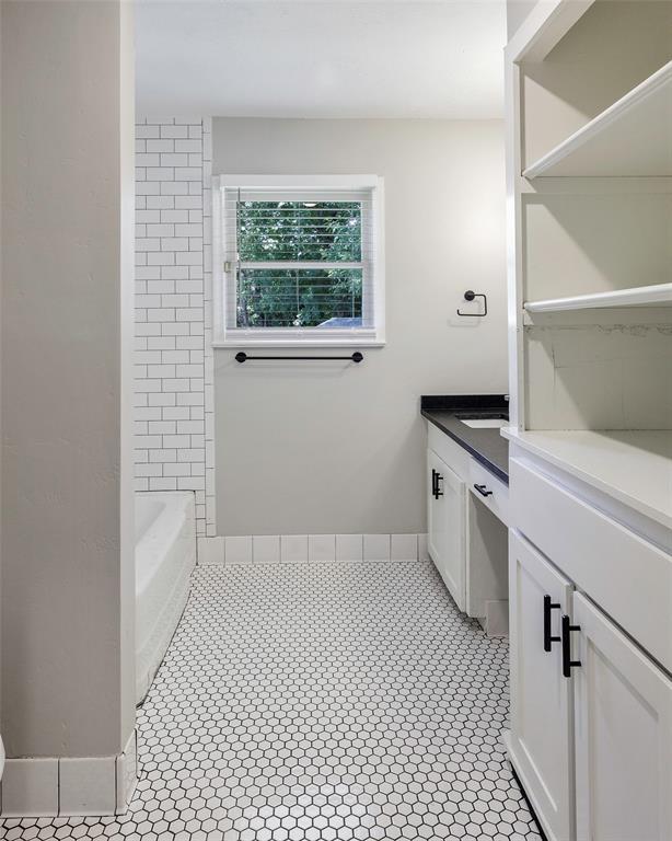 2323 Sutter Street Dallas, TX 75216 - Photo 27 of 30 Bathroom with tile flooring, vanity, and shower combination