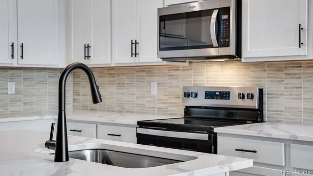 a kitchen with stainless steel appliances a stove and cabinets