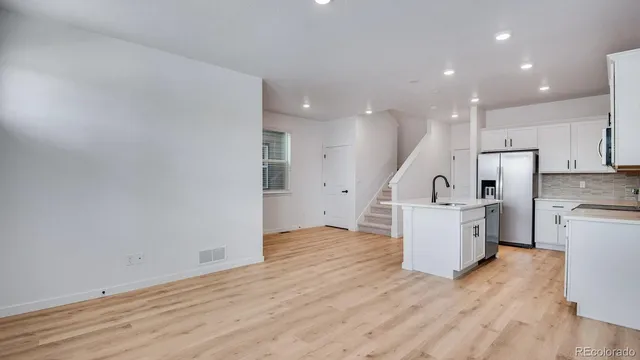 a view of kitchen with cabinets and wooden floor