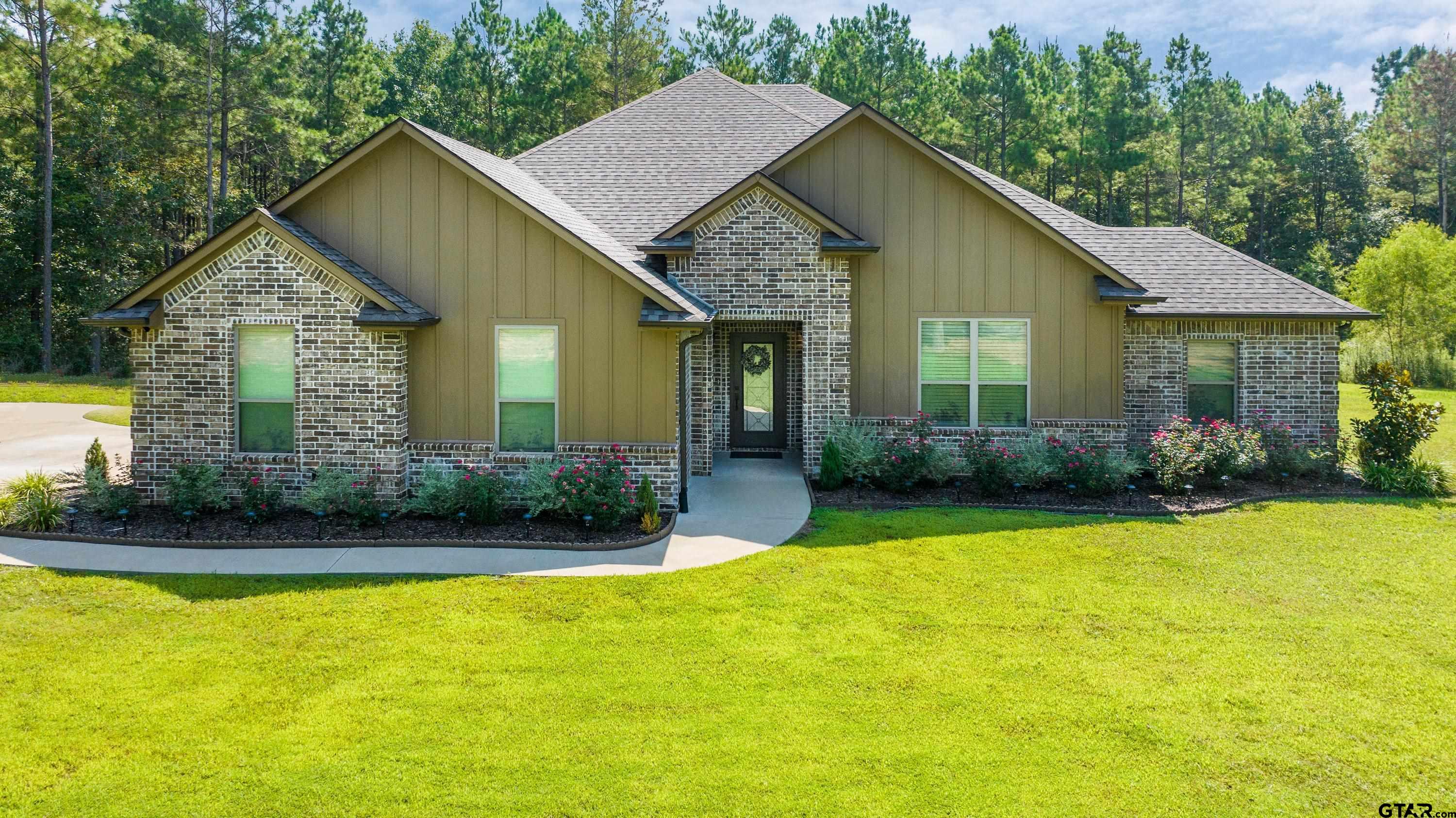 8199 Cr 314 Street South Laneville, TX 75667 - Photo 1 of 47 a front view of a house with garden