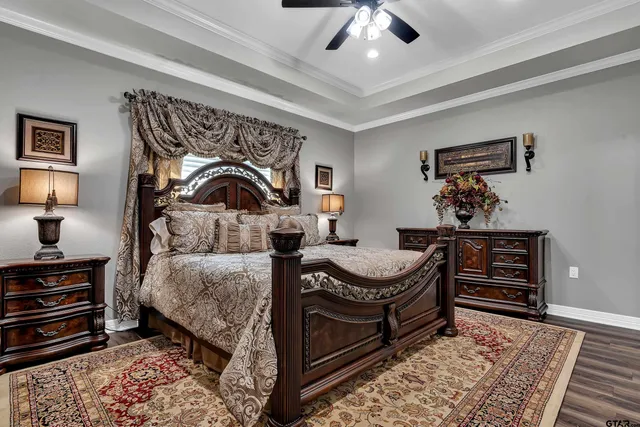 a bedroom with a bed and a chandelier