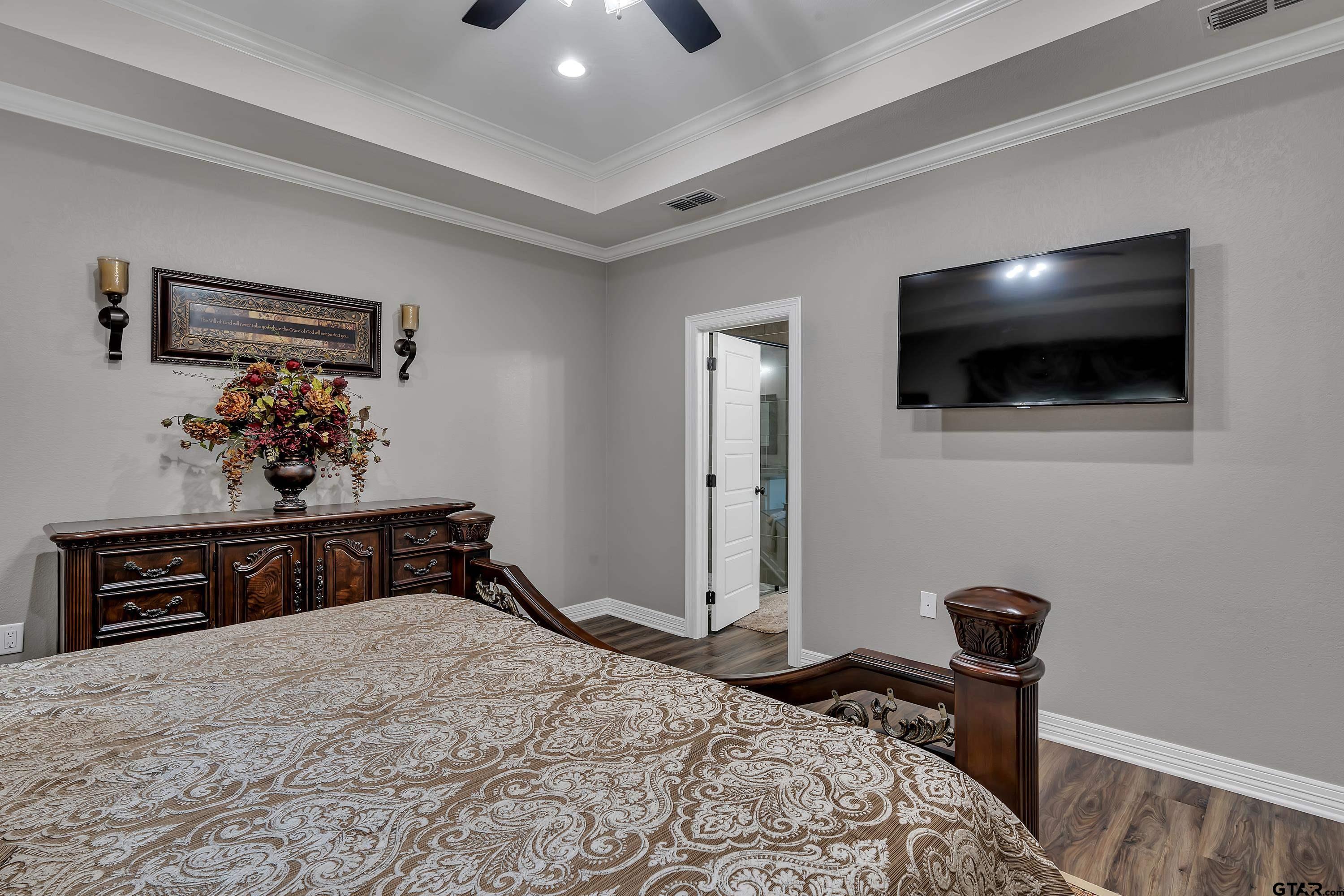 8199 Cr 314 Street South Laneville, TX 75667 - Photo 18 of 47 a bedroom with a bed and a flat screen tv