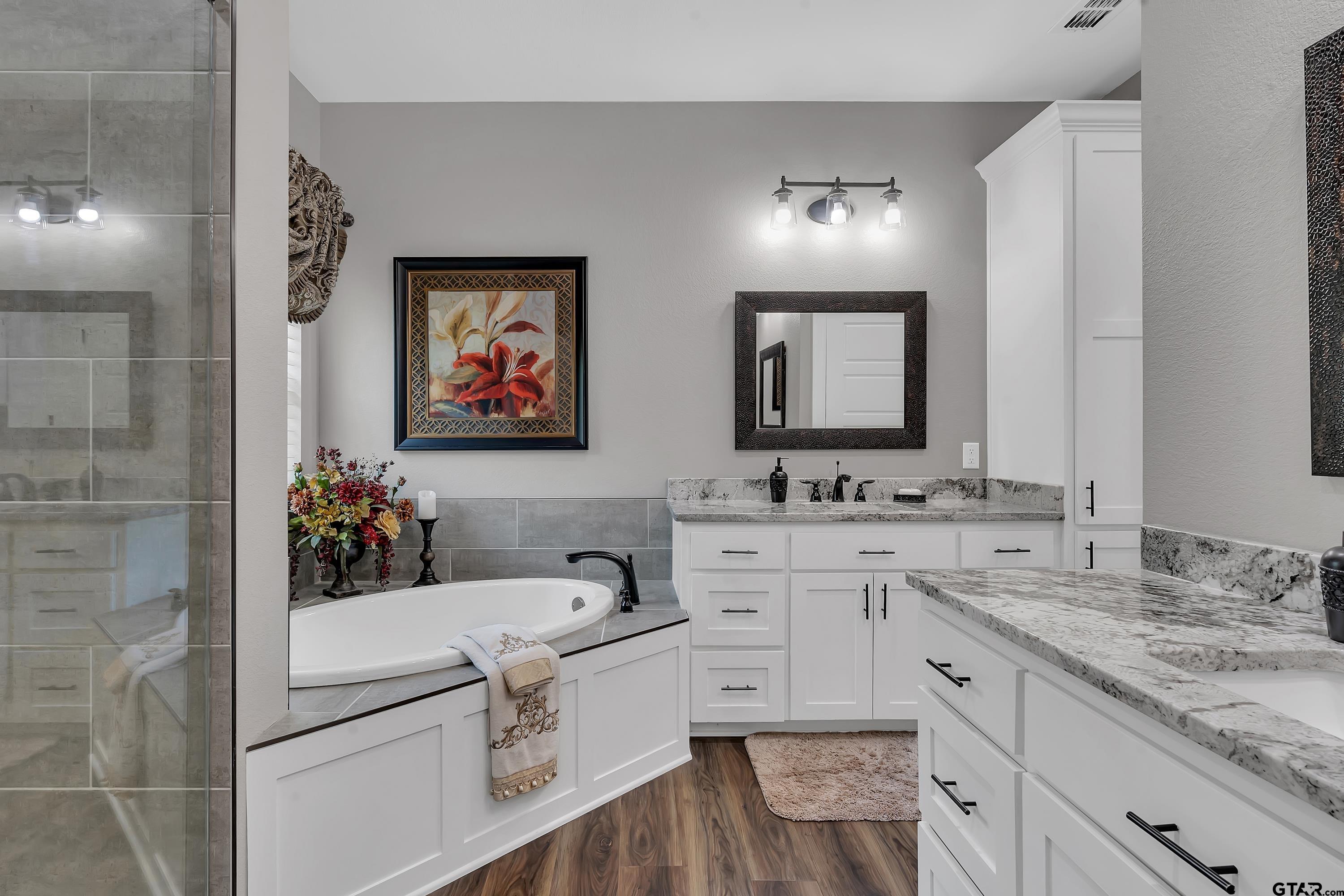 8199 Cr 314 Street South Laneville, TX 75667 - Photo 19 of 47 a bathroom with a granite countertop sink a large mirror and a shower