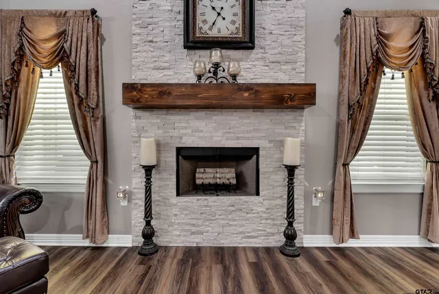 a living room with a fireplace and a wooden floor
