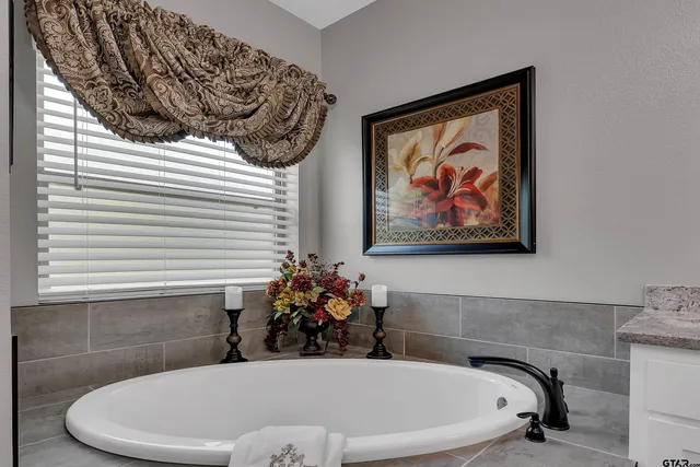 a bath tub sitting in a bathroom next to a window