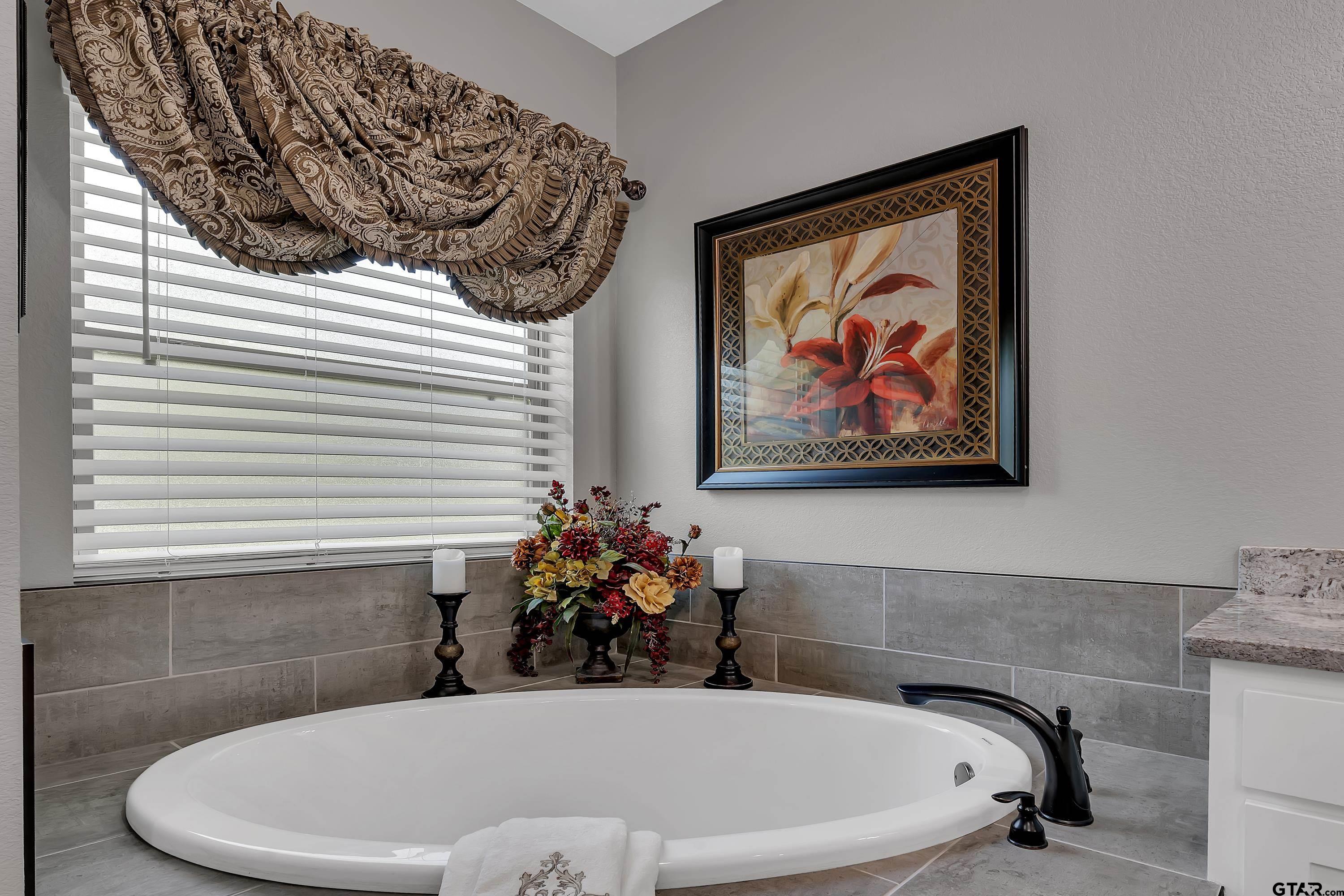 8199 Cr 314 Street South Laneville, TX 75667 - Photo 21 of 47 a bath tub sitting in a bathroom next to a window