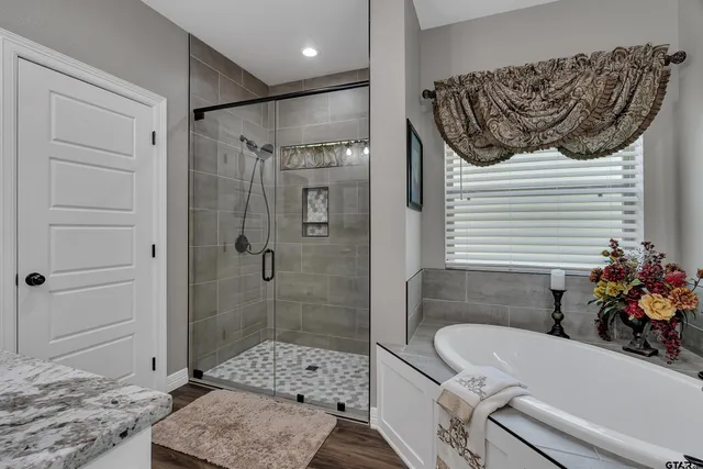a bathroom with a tub and a shower