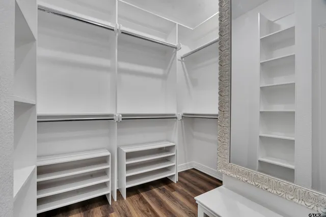 a view of walk in closet with empty racks