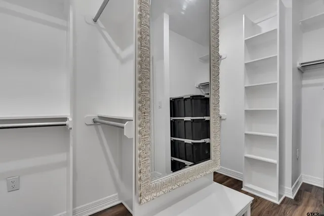 a view of walk in closet with empty racks