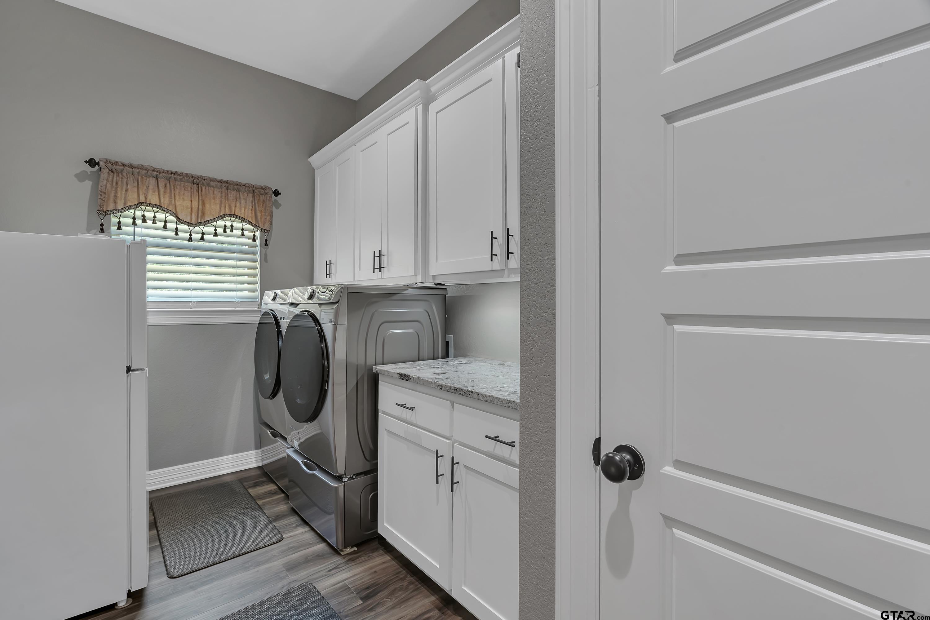 8199 Cr 314 Street South Laneville, TX 75667 - Photo 25 of 47 a utility room with cabinets washer and dryer