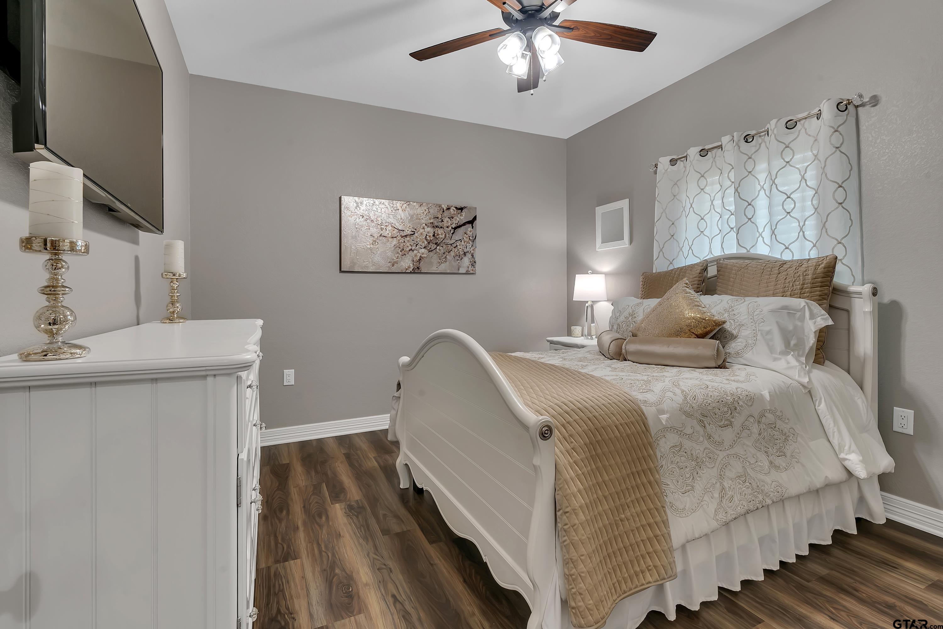 8199 Cr 314 Street South Laneville, TX 75667 - Photo 26 of 47 a bedroom with a bed and a chandelier