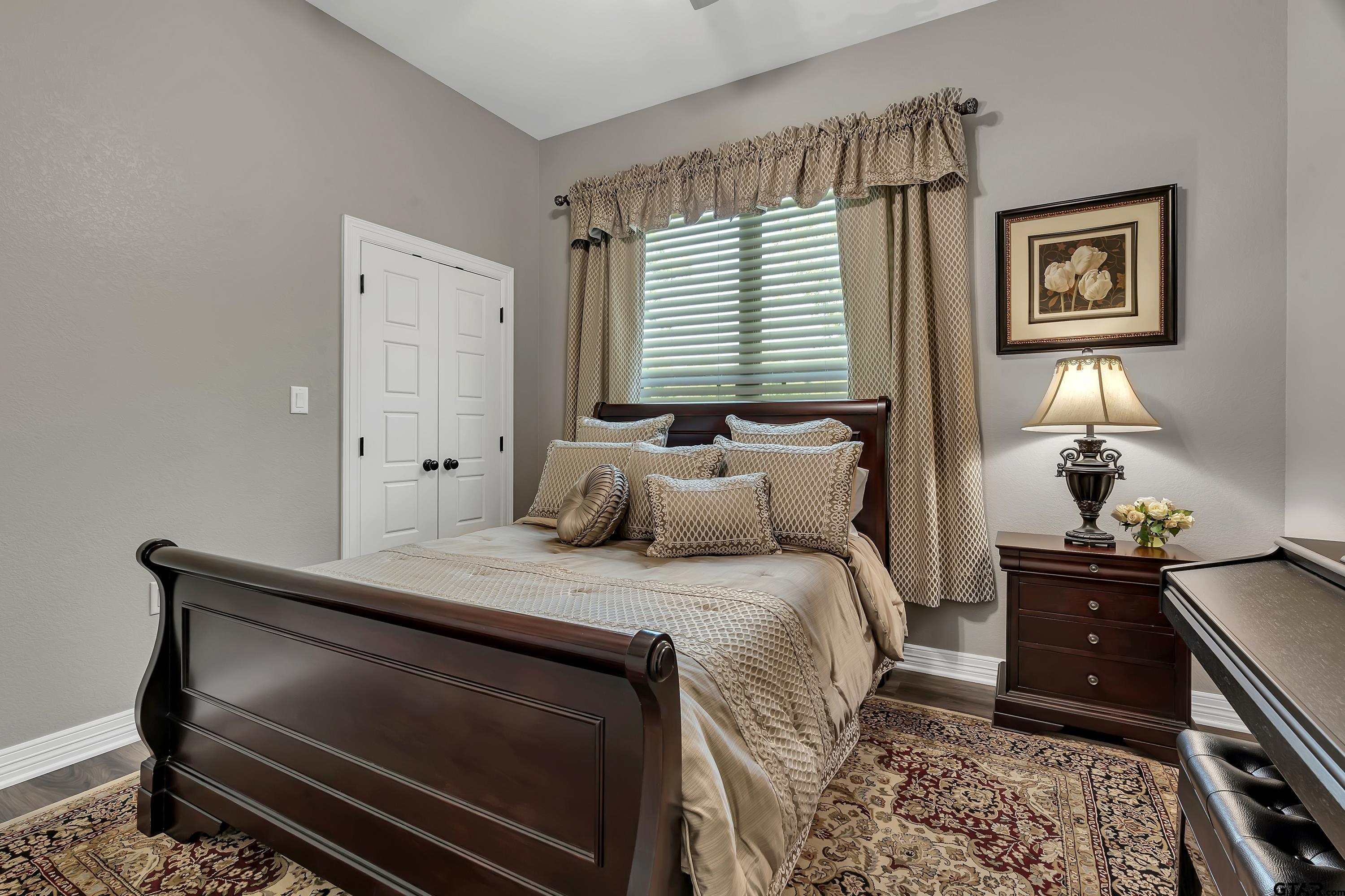 8199 Cr 314 Street South Laneville, TX 75667 - Photo 27 of 47 a bedroom with a bed and a lamp on dresser