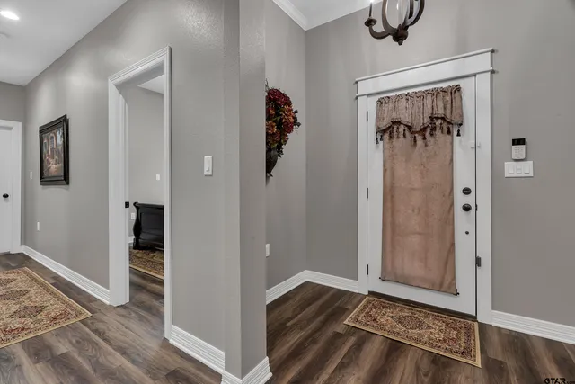 a view of a hallway view with wooden floor and staircase