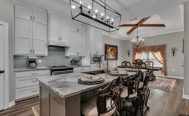 a kitchen with a table chairs stove and cabinets