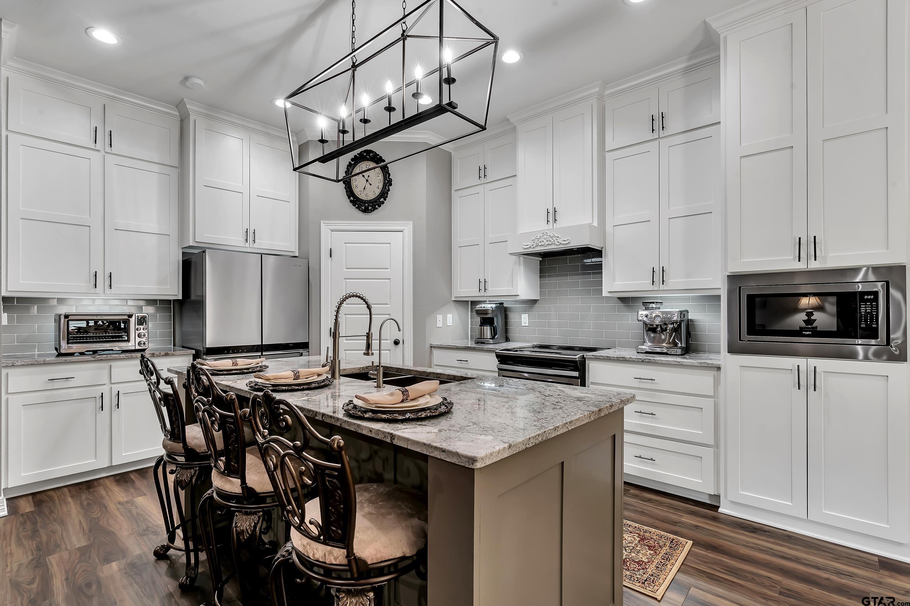 8199 Cr 314 Street South Laneville, TX 75667 - Photo 9 of 47 a kitchen with stainless steel appliances granite countertop a stove a sink a microwave and cabinets