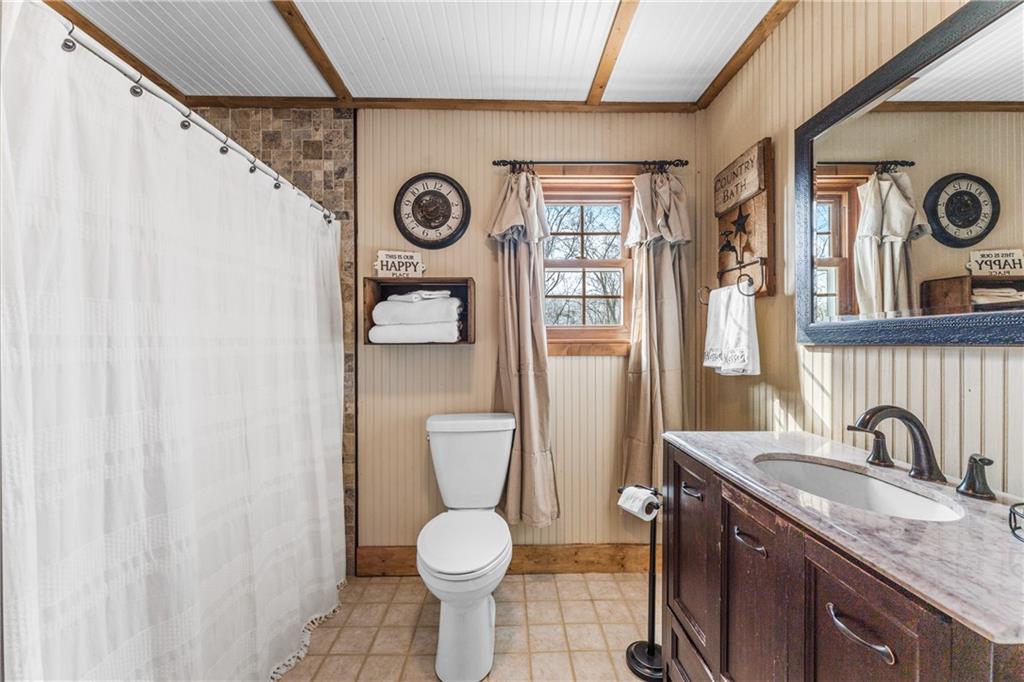 4689 Bell Road Cochranton, PA 16314 - Photo 12 of 32 a bathroom with a toilet sink and mirror